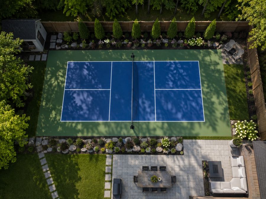 Overhead aerial view of a finished backyard pickleball court and patio